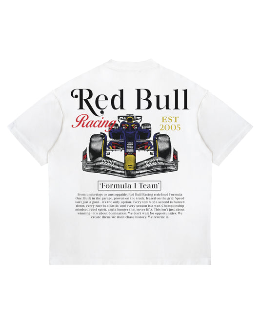 White oversized Red Bull Racing T-shirt featuring F1 car rear graphic and team heritage paragraph.